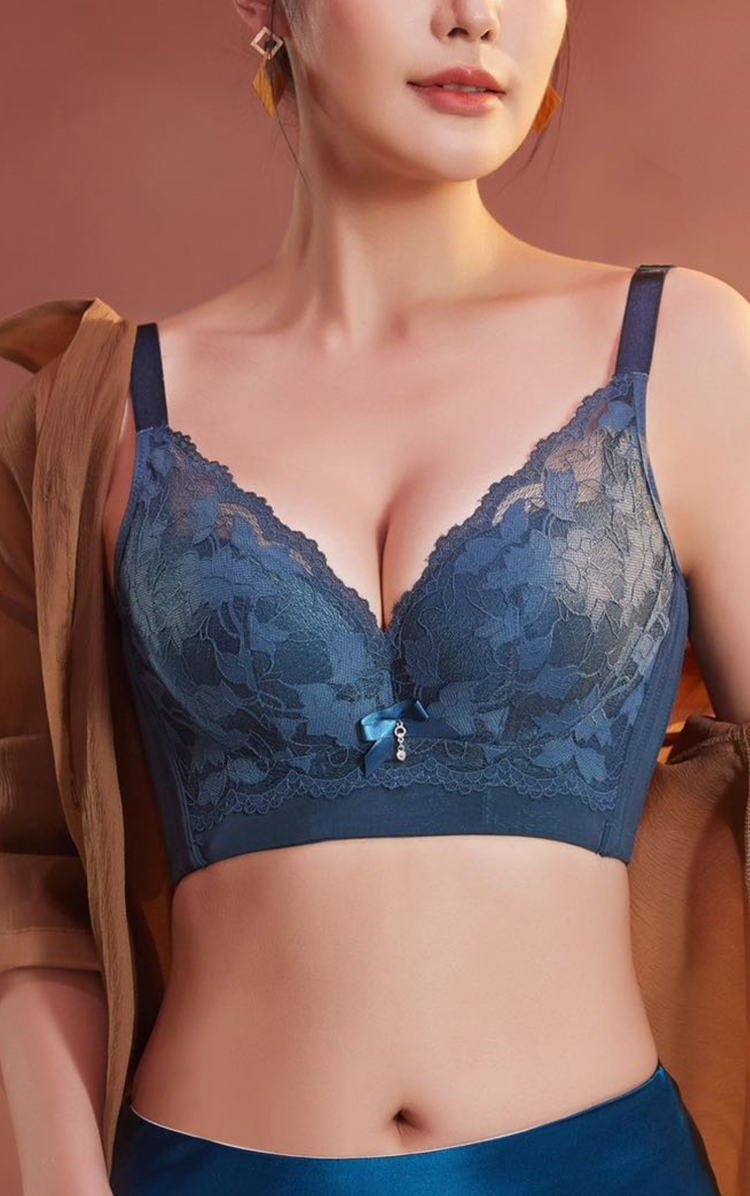 A deep green lace underwire bra with a delicate floral pattern, front bow detail, and wide supportive sidebands for a comfortable fit.