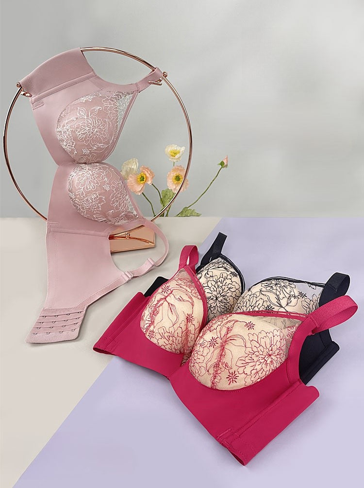Display of pink and red floral embroidered lace bras with medium-thick molded cups, showcasing their elegant design and intricate lace details.