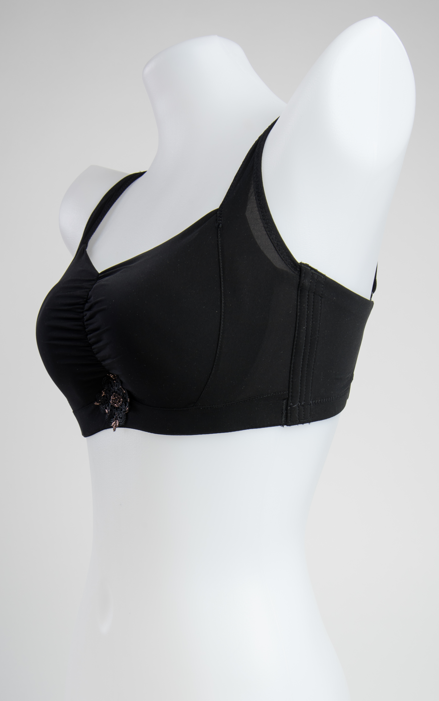Side view of black seamless wireless contour bra showing back-smoothing design and four-row hook