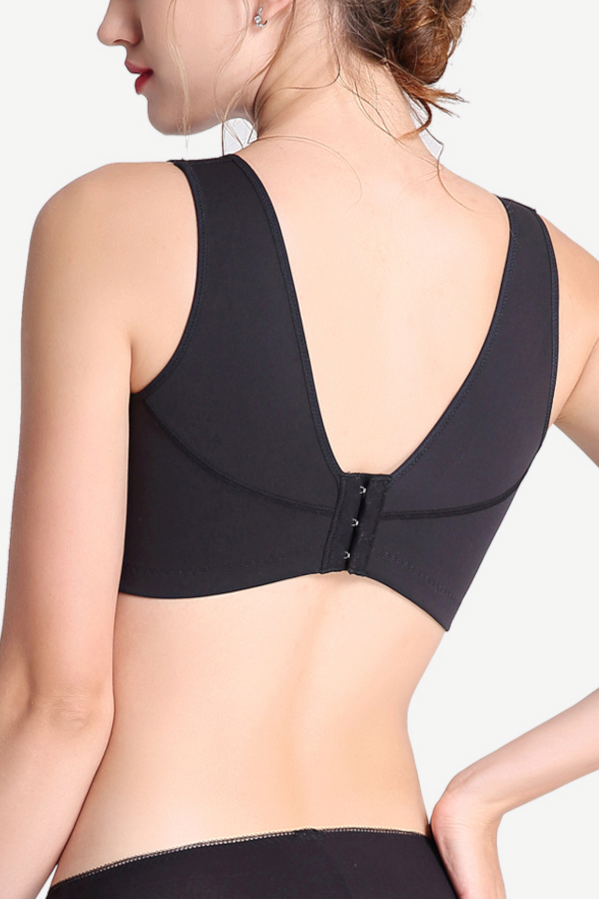 Side view of black wireless mesh sports contour bra showing breathable panels and supportive design