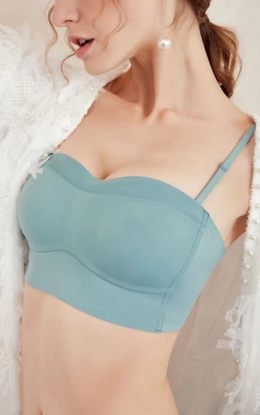 Side view of a woman wearing a blue strapless bra, showing the fit around the bust and sidebands.