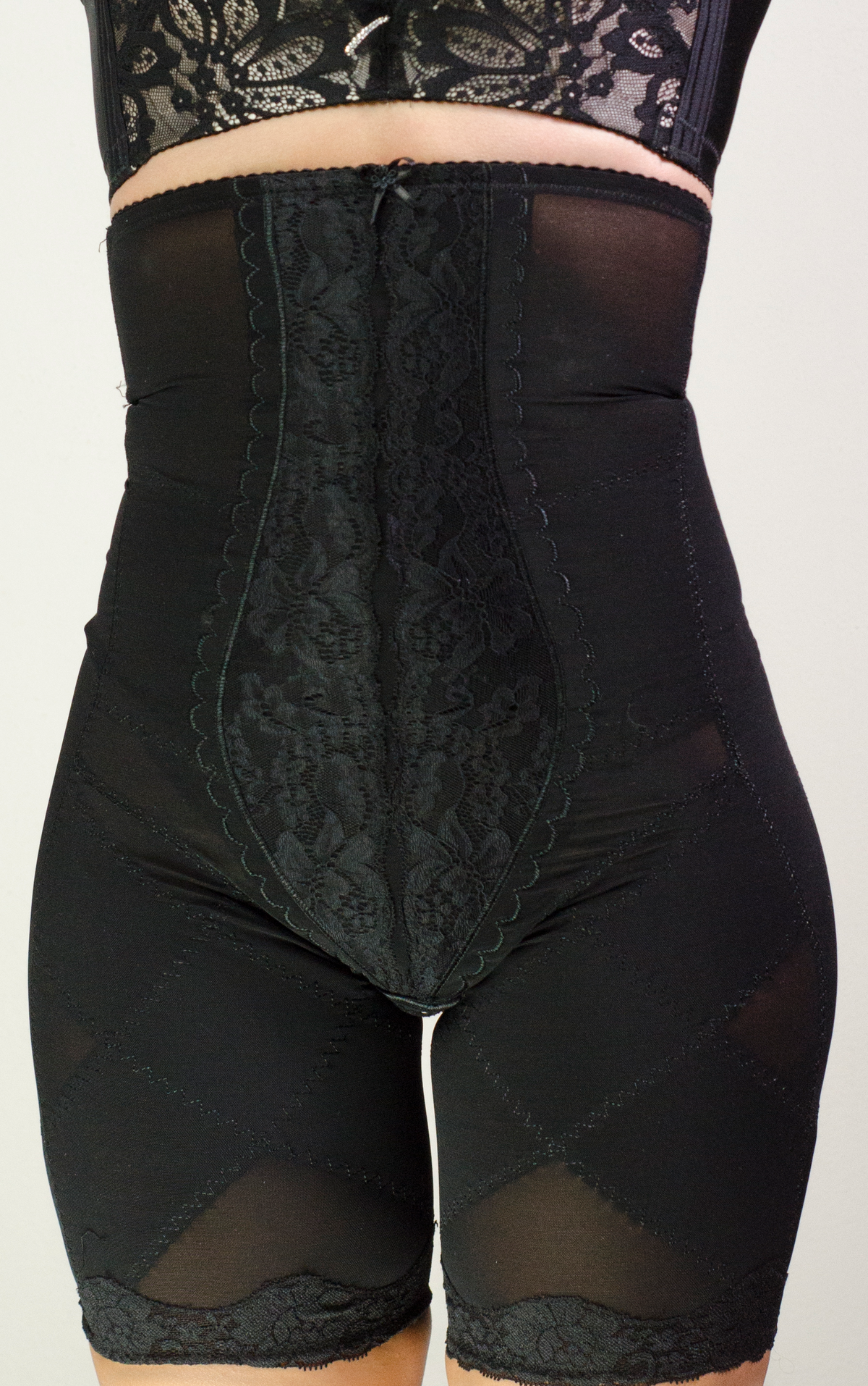 Side view of black high-waist lace thigh slimmer shapewear shorts with firm control