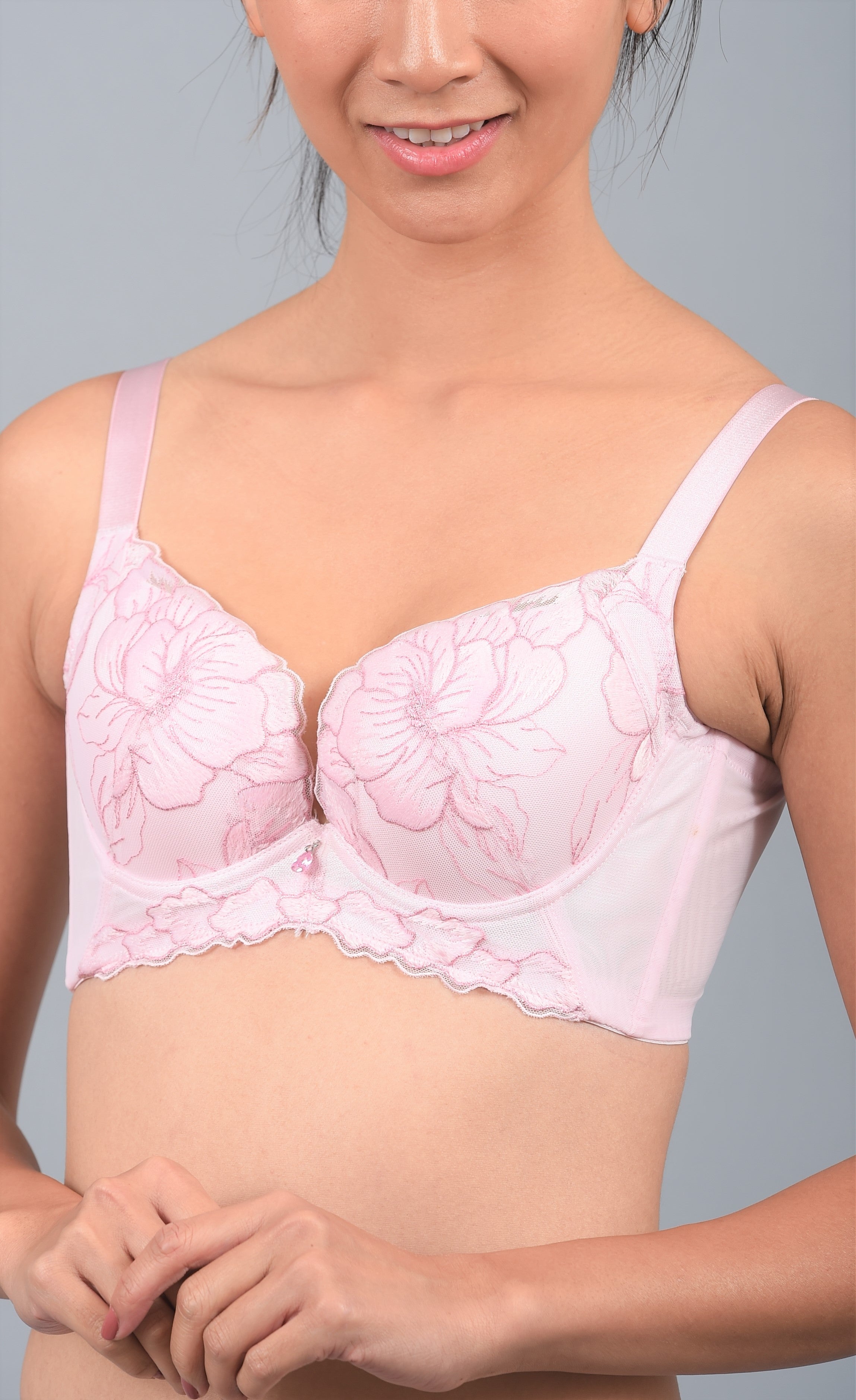 Angled view of pink underwire contour bra highlighting floral lace cup detailing