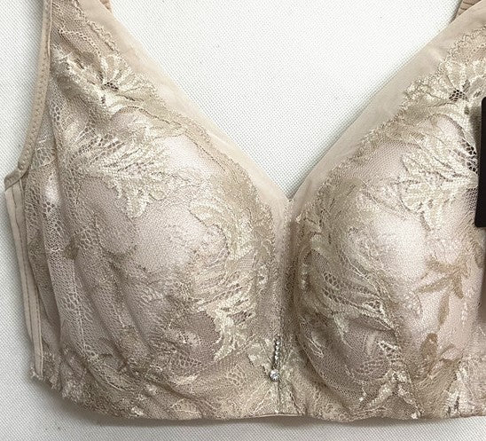 Front view of beige wireless full cup minimizer contour bra with wide straps and lace detailing