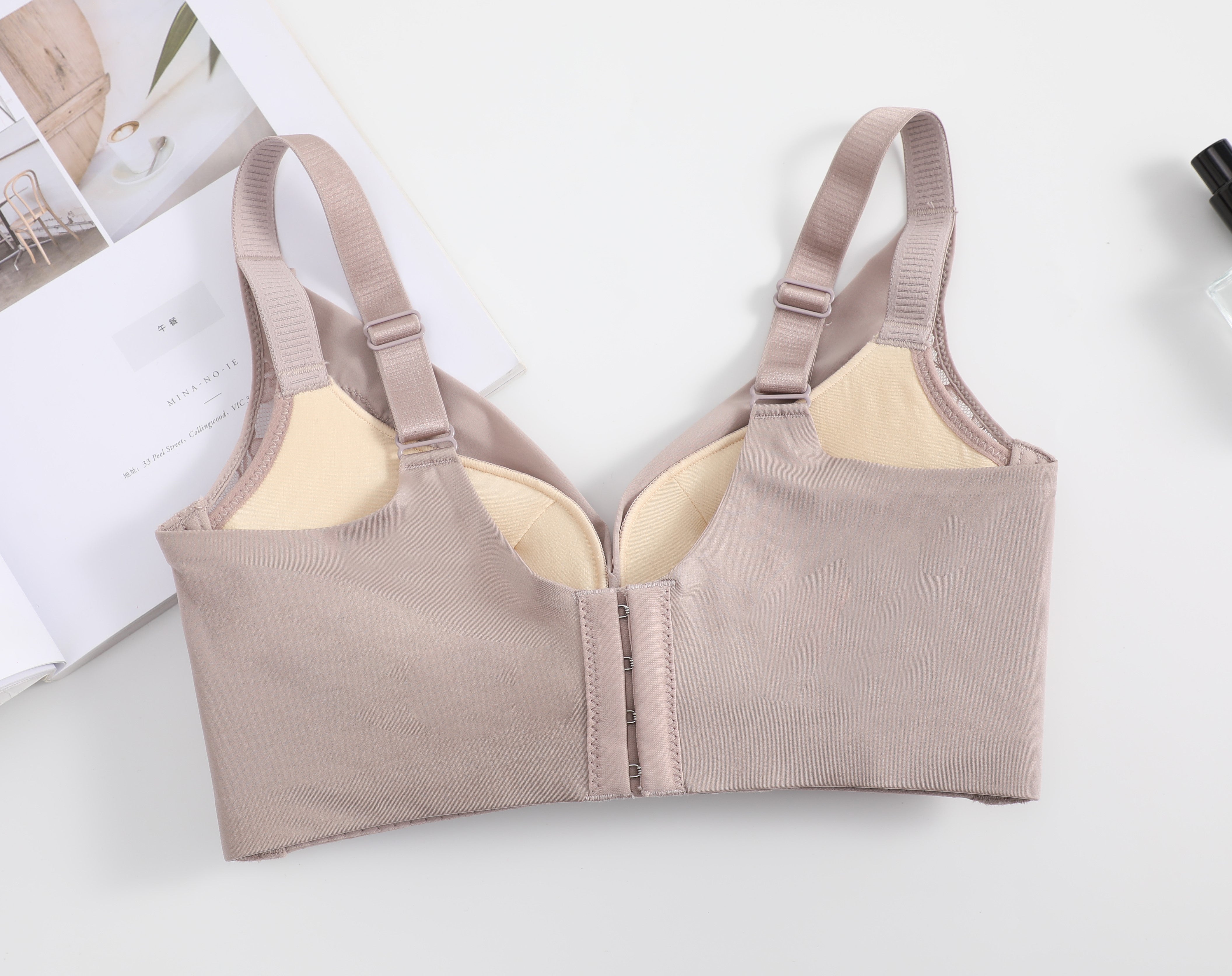 Back view of a pink wireless push-up bra, showing the U-shaped design, adjustable straps, and smooth finish for added support.